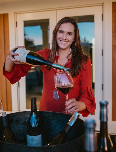 Kara pouring wine